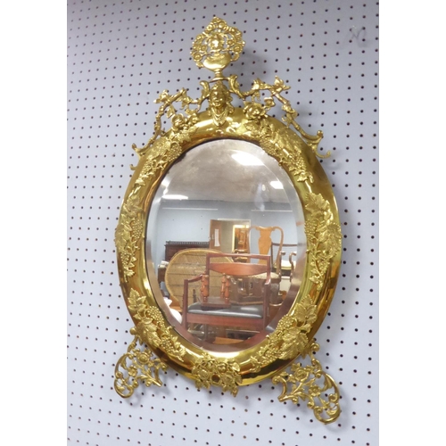 84 - NAPOLEON III BRASS FRAMED WALL MIRROR, the oval, bevel edged plate, within a conforming, moulded fra... 