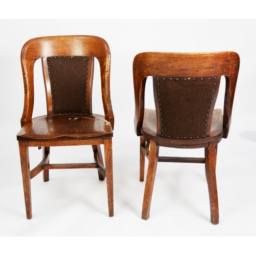 148 - SET OF FIVE EARLY TWENTIETH CENTURY HEAVY OAK LIBRARY OR BOARDROOM CHAIRS, each with central pad, co... 