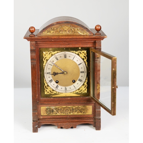 68 - EARLY TWENTIETH CENTURY BRASS MOUNTED OAK MANTEL CLOCK, the 7” brass dial with silvered chapter ring... 