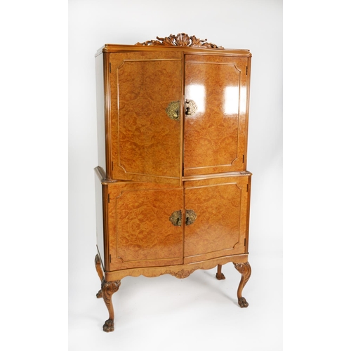 204 - HURWITZ OF LEEDS, GEORGE II STYLE FIGURED AND CAVED WALNUT SERPENTINE FRONTED COCKTAIL CABINET, the ... 