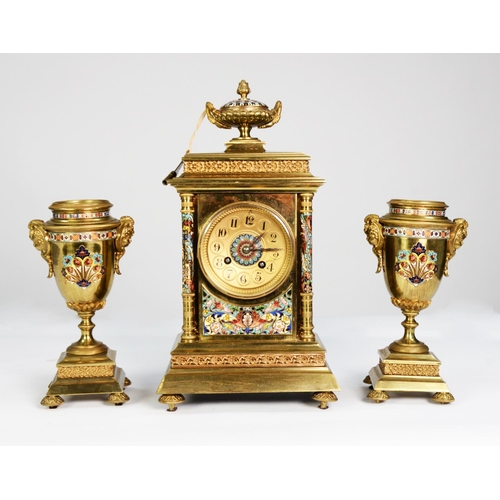 70 - CIRCA 1900 FRENCH GILDED BRASS AND CHAMPLEVE ENAMEL CLOCK GARNITURE, the movement striking on a coil... 