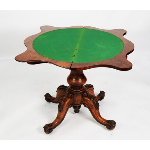 159 - VICTORIAN FIGURED AND CARVED WALNUT PEDESTAL CARD TABLE, the fold-over top of serpentine outline wit... 