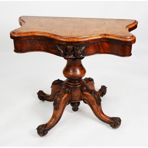 159 - VICTORIAN FIGURED AND CARVED WALNUT PEDESTAL CARD TABLE, the fold-over top of serpentine outline wit... 