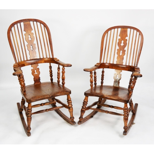 141 - NEAR PAIR OF NINETEENTH CENTURY ELM AND FRUITWOOD WINDSOR ROCKING CHAIRS, each with two pierced spla... 