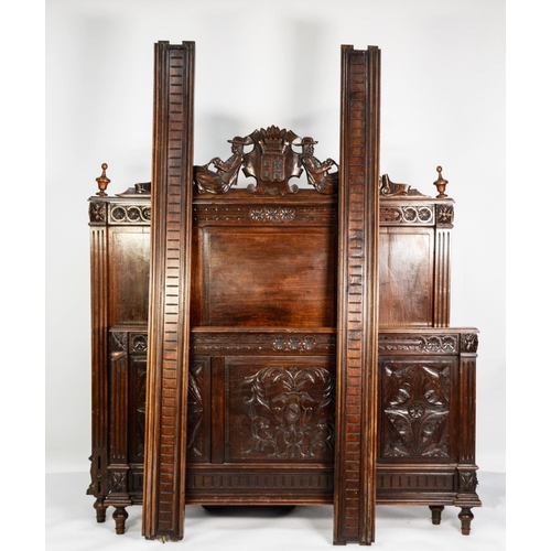 153 - EARLY TWENTIETH CENTURY FRENCH CARVED OAK DOUBLE BED FRAME, the panelled headboard surmounted with a... 