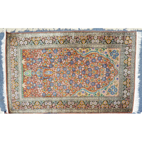 4 - SEMI-ANTIQUE EASTERN PART-SILK PRAYER RUG of vase and flowering shrub design filling the crimson fie... 