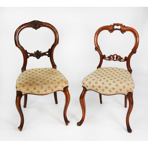 156 - TWO SIMILAR PAIRS OF VICTORIAN CARVED WALNUT DINING CHAIRS, each with waisted back, serpentine front... 