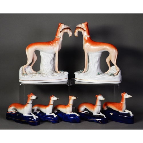 101 - PAIR OF NINETEENTH CENTURY STAFFORDSHIRE FLAT BACK POTTERY MODELS OF GREYHOUNDS, each painted in col... 