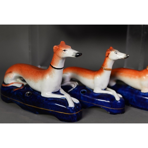 101 - PAIR OF NINETEENTH CENTURY STAFFORDSHIRE FLAT BACK POTTERY MODELS OF GREYHOUNDS, each painted in col... 