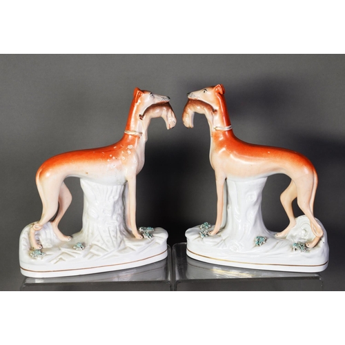 101 - PAIR OF NINETEENTH CENTURY STAFFORDSHIRE FLAT BACK POTTERY MODELS OF GREYHOUNDS, each painted in col... 