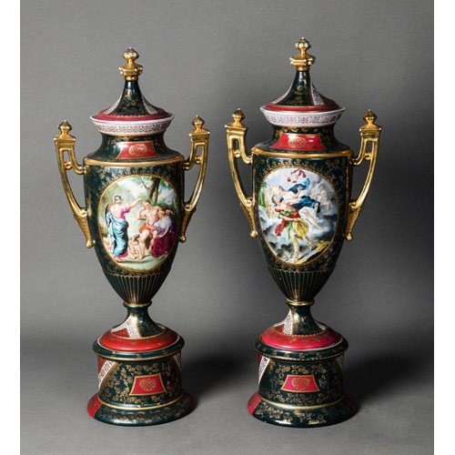 103 - PAIR OF TWENTIETH CENTURY VIENNA STYLE PORCELAIN TWO HANDLED PEDESTAL VASES AND COVERS, each of slen... 