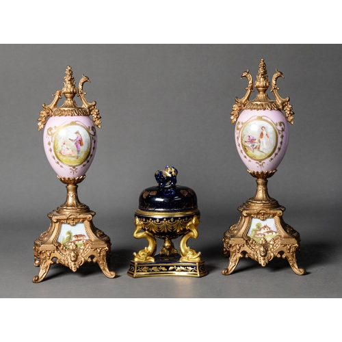 104 - PAIR OF LATE NINETEENTH/ EARLY TWENTIETH CENTURY GILT METAL AND PORCELAIN PEDESTAL URNS, originally ... 