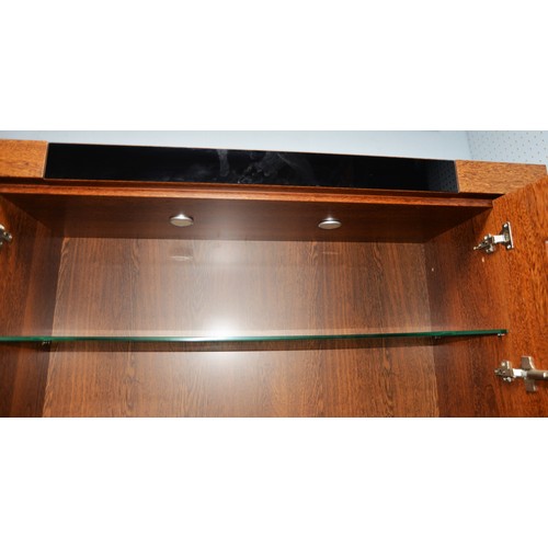 89 - MODERN DISPLAY CABINET, with a pair of glazed cupboard doors enclosing three shelves, set above a pa... 