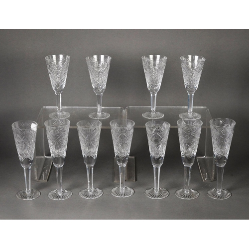 42 - SET OF SEVEN CUT GLASS CHAMPAGNE FLUTES, on hexagonally panelled tapering stems and star cut bases a... 