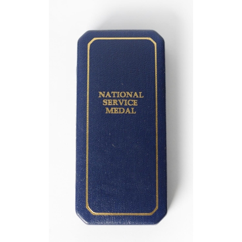 35 - CASED NATIONAL SERVICE MEDAL, with ribbon and plastic card numbered 28022