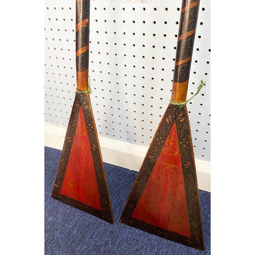 242 - PAIR OF POSSIBLY SOUTH EAST ASIAN LACQUERED WOODEN PADDLES, the blades of triangular form with gilt ... 