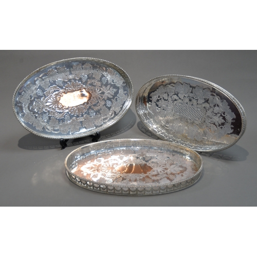 431 - PAIR OF VINERS SILVER PLATED ON COPPER OVAL GALLERIED TRAYS, each with chased fruiting vine centre a... 