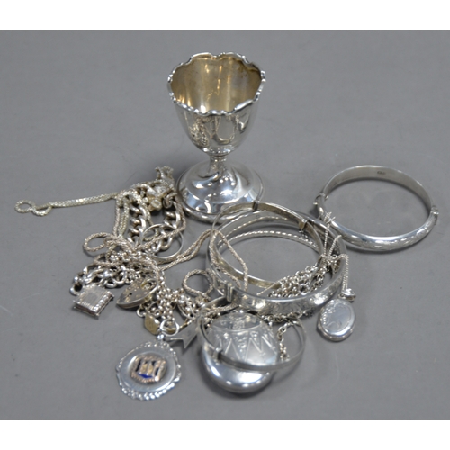 393 - WEIGHTED SILVER EGG CUP, Birmingham 1926, FIVE SMALL SILVER STIFF BANGLES, TWO SILVER LOCKETS ON CHA... 