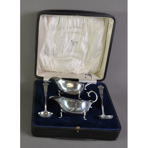 379 - GEORGE VI CASED PAIR OF SILVER SAUCE BOAT AND TREFID LADLES BY WILLIAM HUTTON & Co Ltd, retailed... 