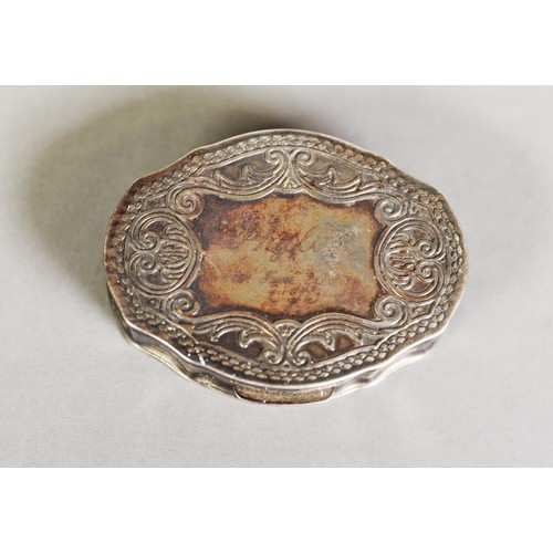 409 - ELIZABETH II SILVER PILL BOX, shaped oval form, the hinged cover repoussé with scrolls and beaded ed... 