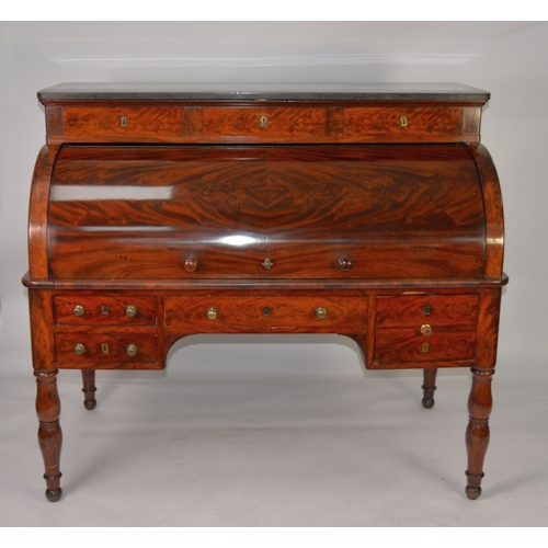 69 - VICTORIAN MAHOGANY DESK, with granite top and cylinder-roll opening to reveal drawers and pigeon hol... 