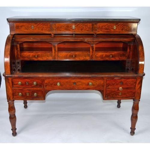 69 - VICTORIAN MAHOGANY DESK, with granite top and cylinder-roll opening to reveal drawers and pigeon hol... 