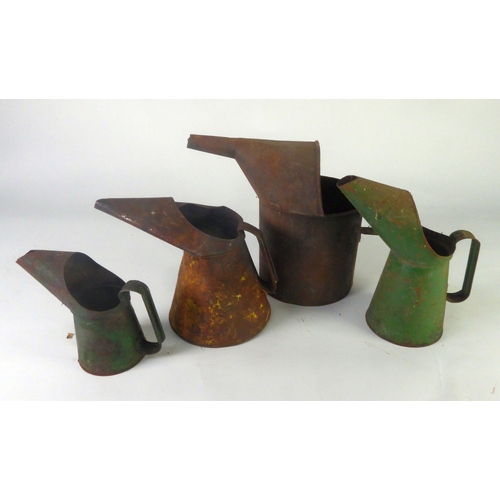 278 - AUTOMOBILIA: Four assorted and graduated workshop oil jugs, 11