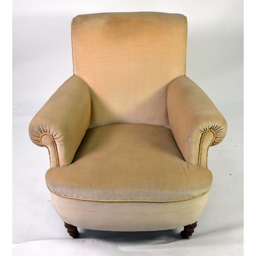 72 - A HOWARD STYLE BOW FRONT ARMCHAIR covered in Beige fabric raised on turned front legs