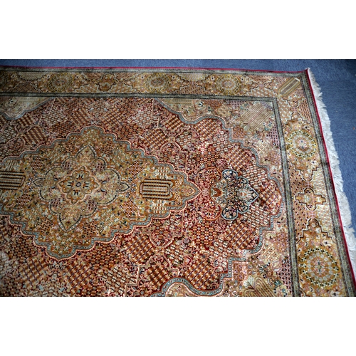 17 - PROBABLY KASHMIR, FINELY HAND KNOTTED ALL-SILK CARPET IN KIRMAN STYLE, with two concentric lobed and... 