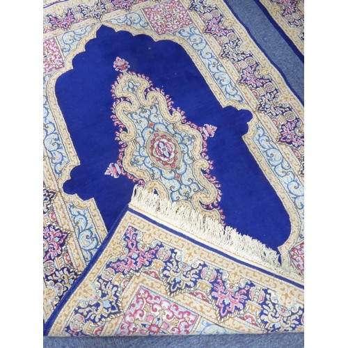 20 - PAIR OF KIRMAN, PERSIAN RUGS each with a narrow lozenge shaped centre medallion, on a dark blue plai... 