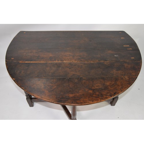 56 - 18th CENTURY DROP_LEAF TABLE, on turned legs united by a peripheral stretcher, plus six later rush-s... 