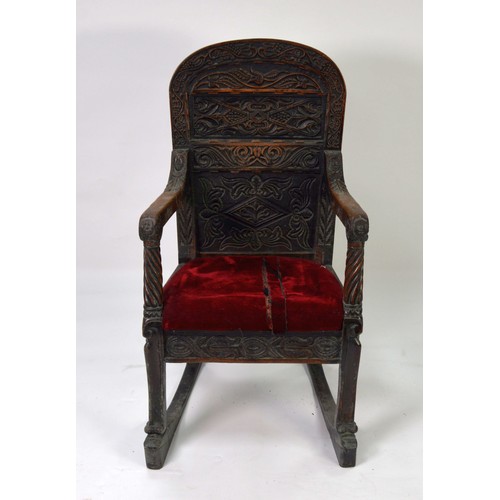 53 - PERIOD OAK: Late 17th/early 18th century oak panel arm chair with relief carved triffid top rail and... 