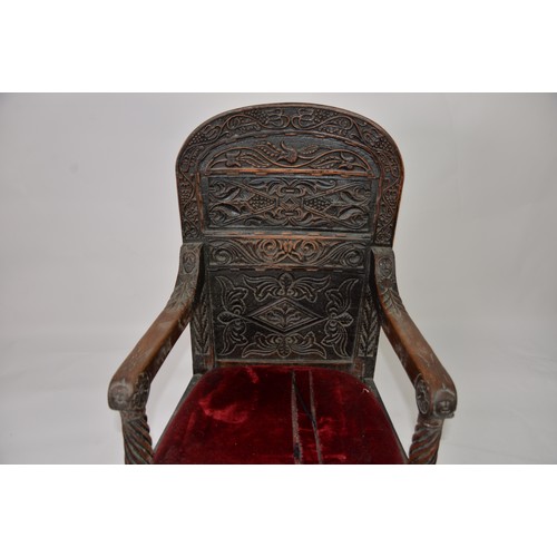 53 - PERIOD OAK: Late 17th/early 18th century oak panel arm chair with relief carved triffid top rail and... 