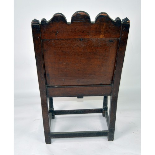 53 - PERIOD OAK: Late 17th/early 18th century oak panel arm chair with relief carved triffid top rail and... 