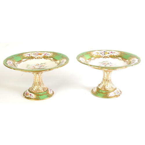 119 - 19th CENTURY COALPORT CHINA PAIR OF PEDESTAL DESSERT DISHES, the bowls painted with exotic birds on ... 