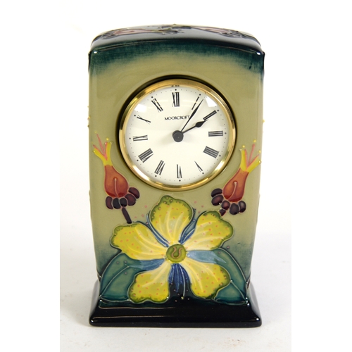 52 - MOORCROFT: Rosehip pattern Moorcroft Pottery quartz mantel clock, fully marked and dated 93 to the b... 