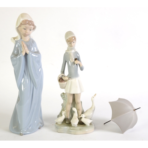 93 - LLADRO PORCELAIN FIGURE OF A GIRL carrying an open umbrella with a family of geese at her feet 9 1/2... 