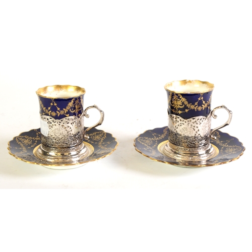 124 - PAIR OF AYNSLEY CHINA COFFEE CANS AND SAUCERS with Martins of Tehran ornate pierced and pictorial en... 