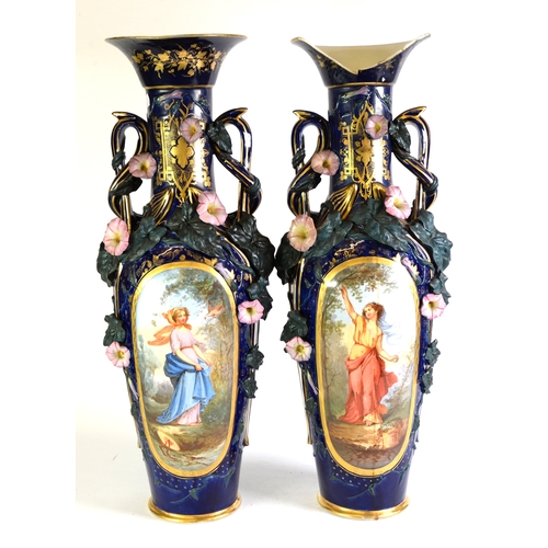 136 - PAIR OF CONTINENTAL LATE 19th CENTURY LARGE PORCELAIN TWO HANDLED VASES, with trumpet topped long ne... 