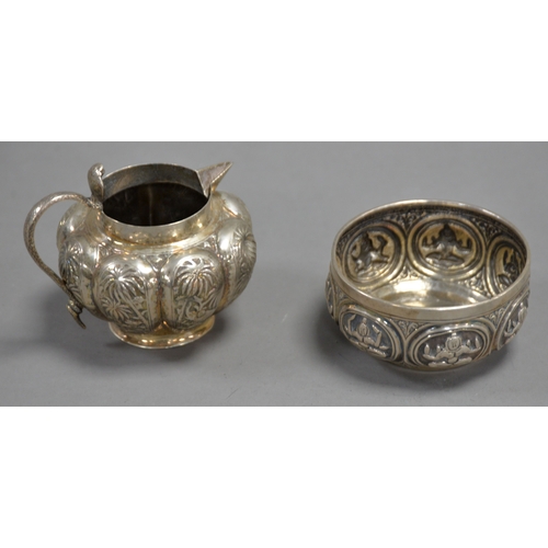 346 - TWO PIECES OF UNMARKED INDIAN EMBOSSED SILVER COLOURED METAL, comprising: MILK JUG, with cobra patte... 