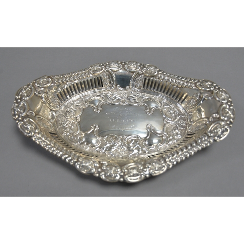 394 - EDWARD VII PIERCED AND EMBOSSED SILVER PRESENTATION TWO HANDLED DISH, of lozenge form, with slot pie... 