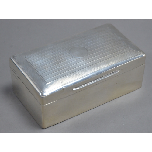 396 - GEORGE V ENGINE TURNED SILVER CLAD TABLE CIGARETTE BOX, of typical form with hardwood lined interior... 