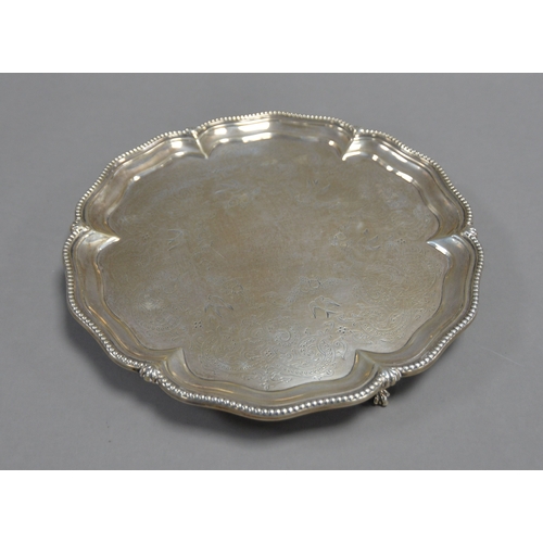 399 - VICTORIAN ENGRAVED SILVER SALVER, of typical form with claw and ball feet, the centre decorated with... 