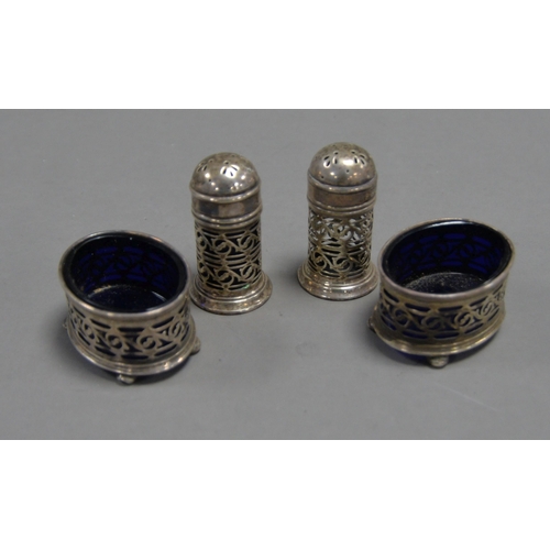 403 - FOUR PIECE PIERCED SILVER CONDIMENT SET, comprising: PAIR OF PEPPERETTES and a PAIR OF OVAL OPEN SAL... 