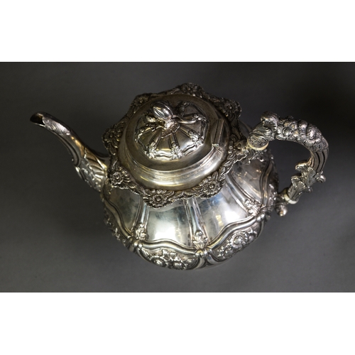 407 - VICTORIAN EMBOSSED SILVER THREE PIECE PEDESTAL TEASET, of bellied form with acanthus capped high scr... 