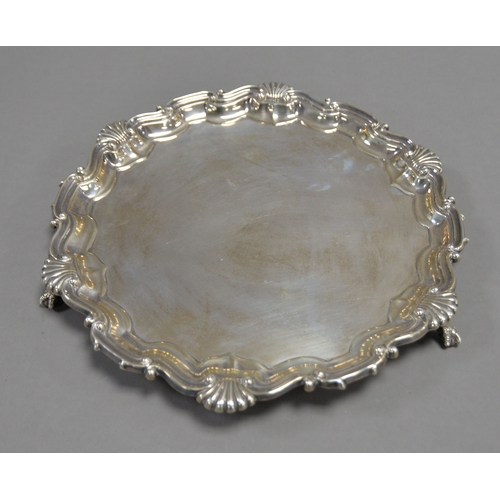 413 - VICTORIAN SILVER SALVER BY MARTIN BROTHERS, with plain centre, shell capped moulded border and claw ... 