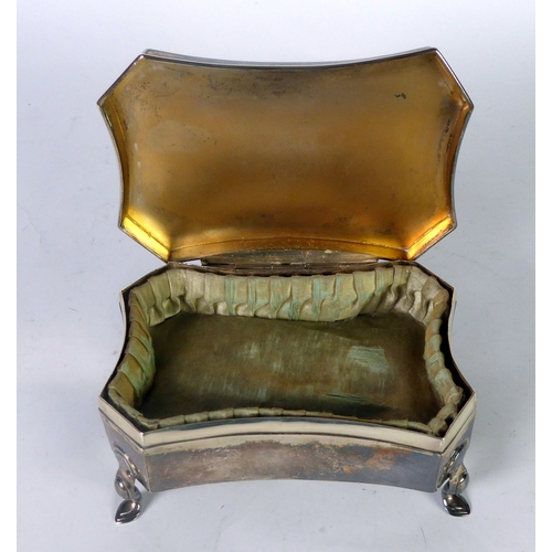 457 - GEORGE V SILVER TRINKET BOX, of shaped oblong form with engine turned border to the flat cover, pale... 