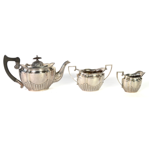 463 - GEORGE V SILVER THREE PIECE TEASET BY CHARLES BOYTTON & SON, of oval part fluted form with angul... 