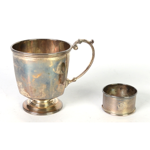 464 - GEORGE V PLAIN SILVER CHILD’S CHRISTENING MUG, of footed form with panelled lower body and high scro... 