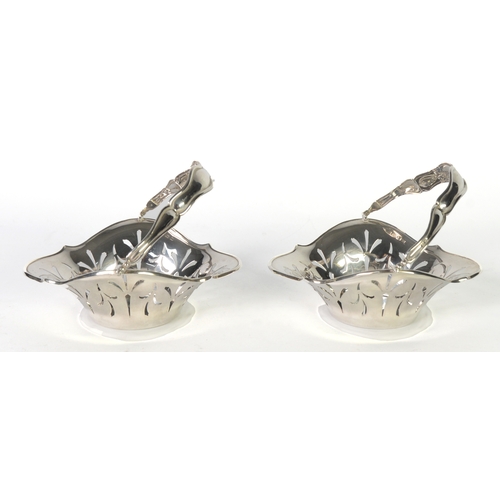 483 - GEORGE V PAIR OF PIERCED SILVER SWING HANDLE BASKET PATTERN BON BON DISHES, each of shaped and flare... 